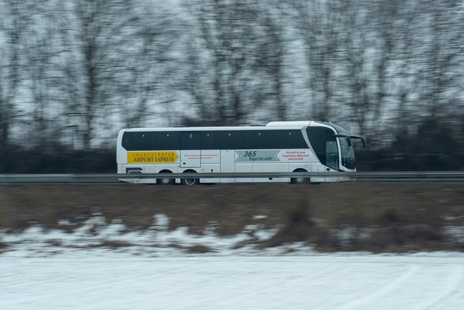A blue Aerobus shuttle bus parked at Barcelona's El Prat airport terminal