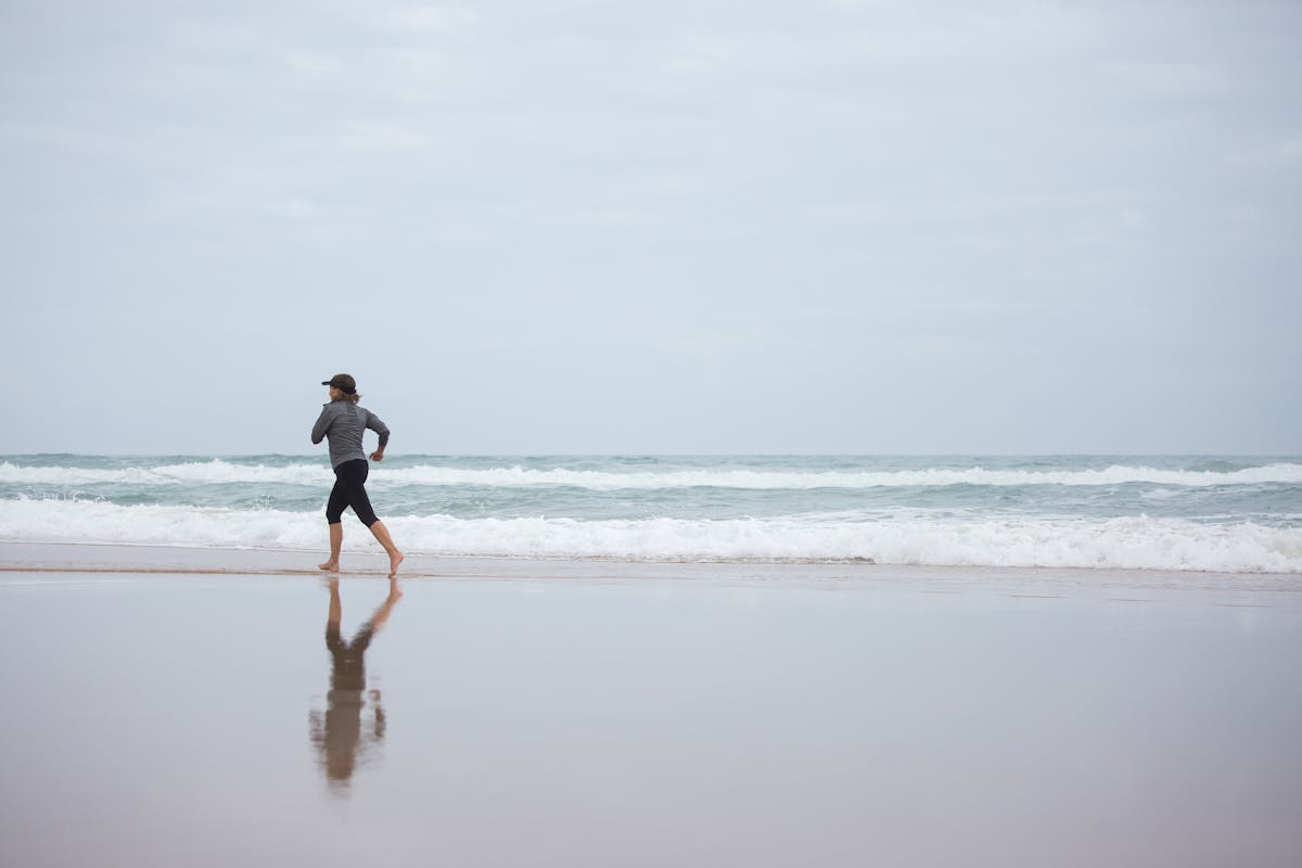 Runner on Barcelona waterfront promenade with sea views