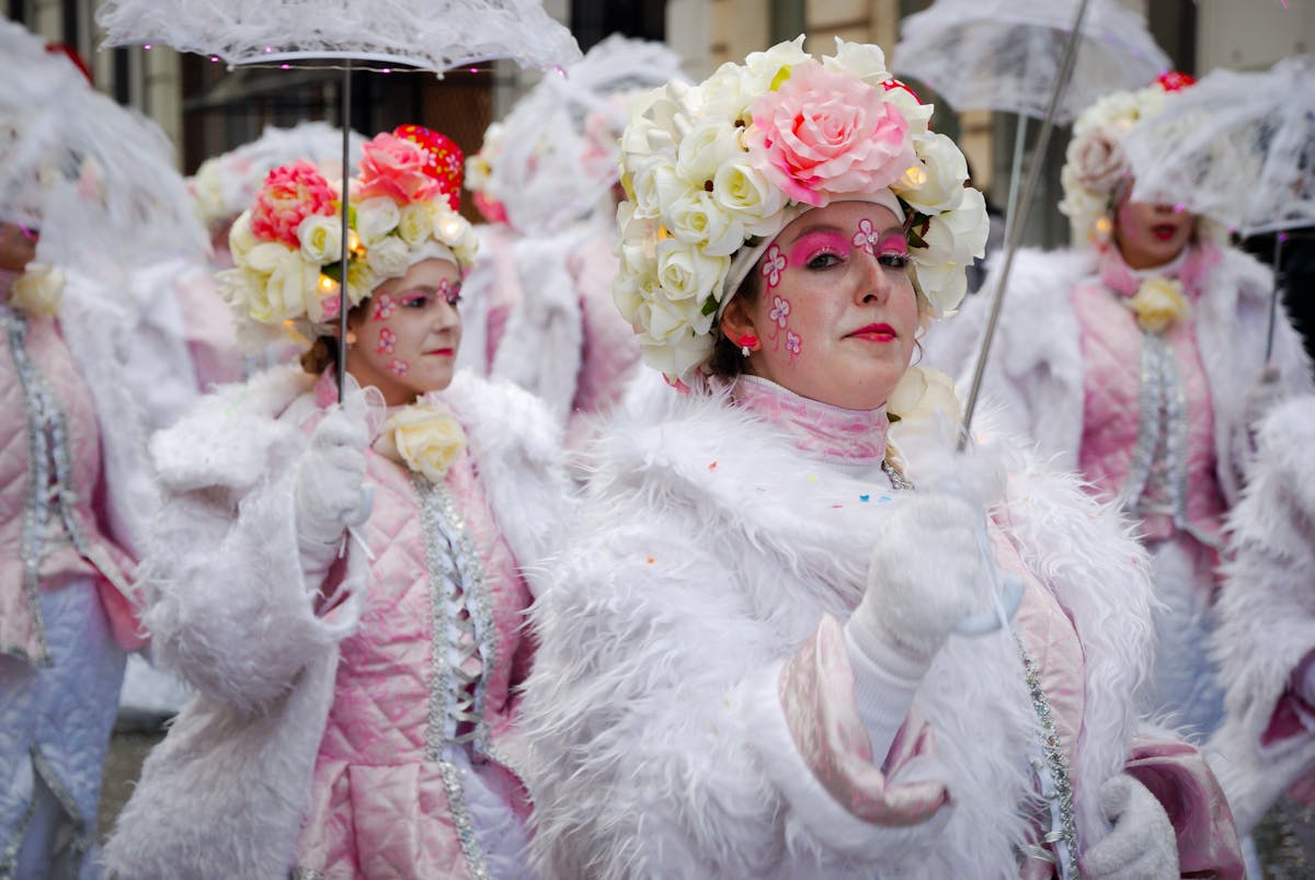 Colorful carnival parade with costumed performers dancing through Barcelona streets