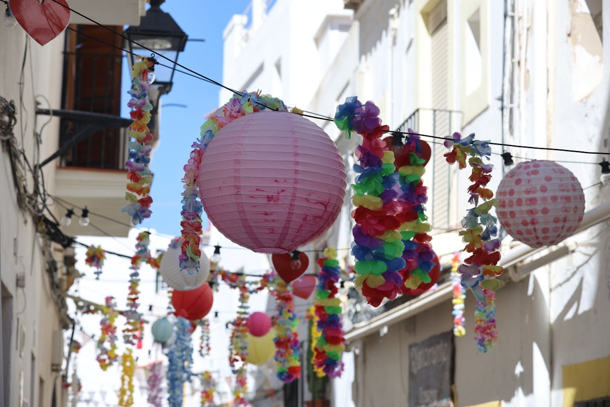Elaborately decorated street during Festes de Gràcia with colorful handmade installations