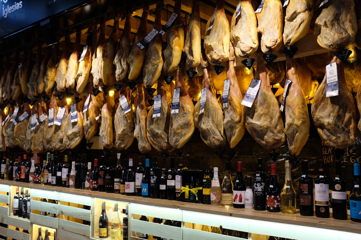 Thinly sliced jamón ibérico on plate, premium Spanish cured ham featured in Barcelona food guide