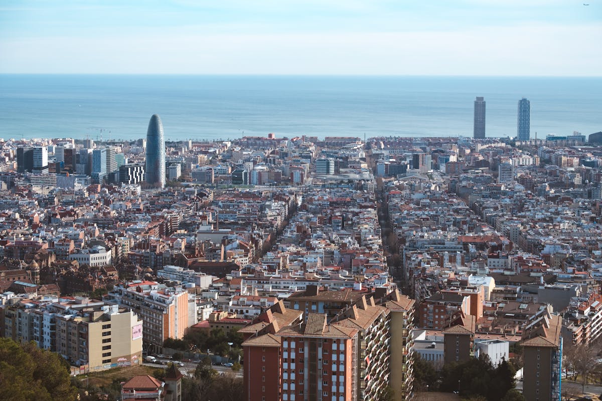 Aerial view of Barcelona cityscape showing the grid layout and Mediterranean coast