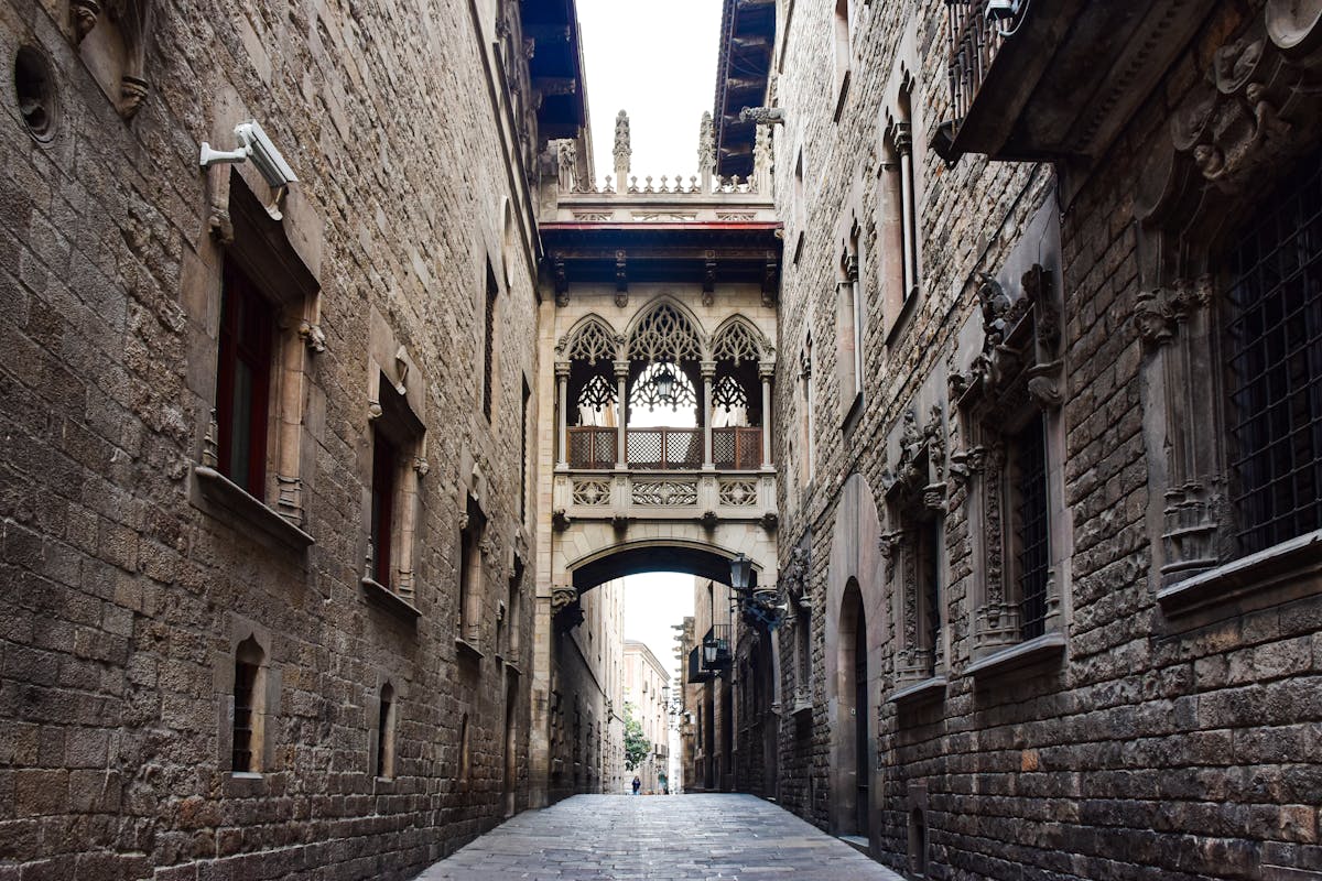 Narrow medieval street in Barcelona's Gothic Quarter with stone arches and morning light
