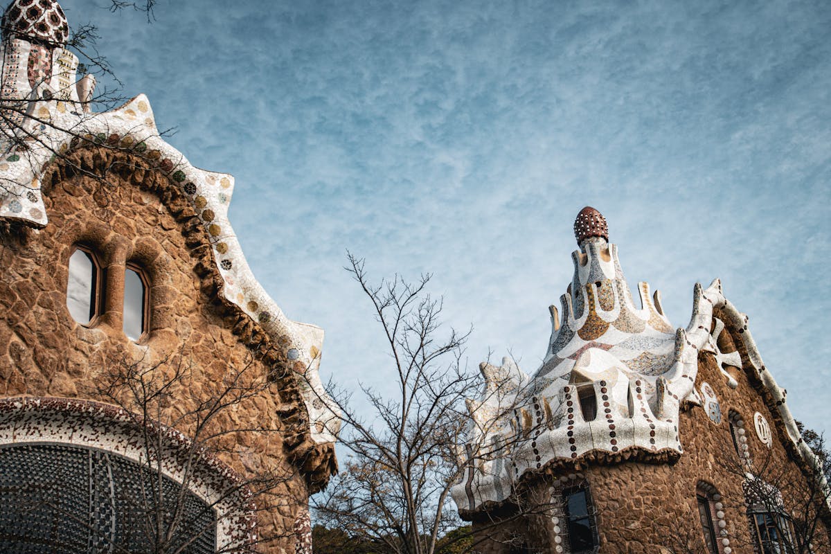 Family exploring the colorful mosaic terraces at Park Güell in Barcelona with kids