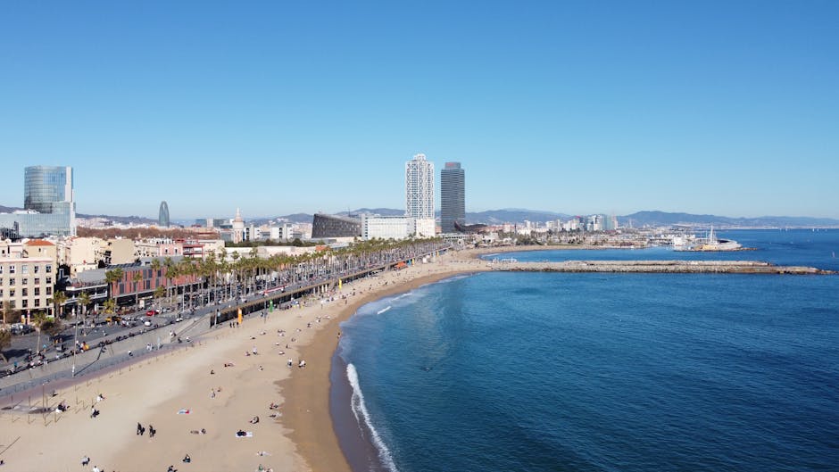 Aerial view of Barcelona's beach coastline showing golden sand, the boardwalk, and the Mediterranean