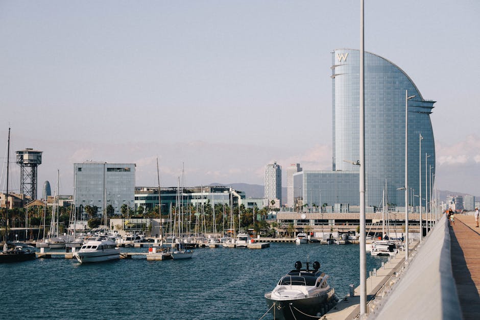 Olympic Marina at night with the lit-up signs of Barcelona's beachside clubs