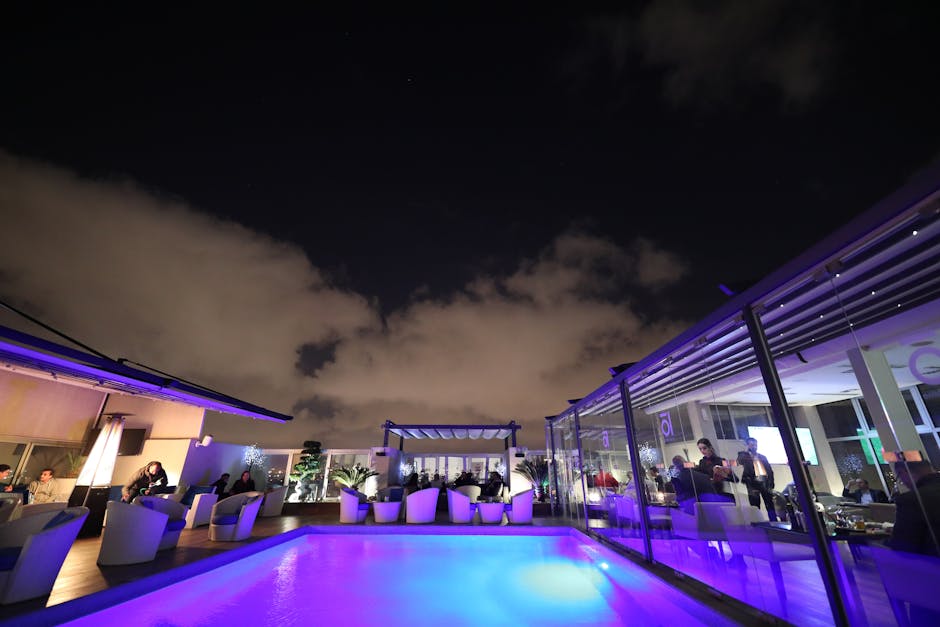 Rooftop beach club in Barcelona at sunset with a DJ and a pool