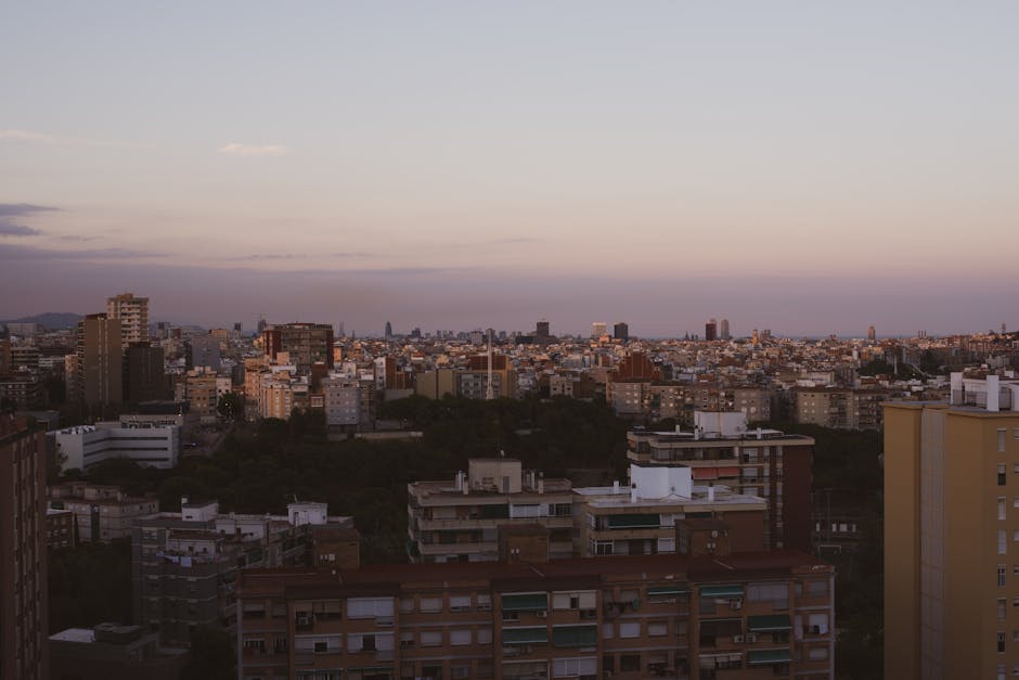 The Bunkers del Carmel viewpoint at sunset with Barcelona's skyline below