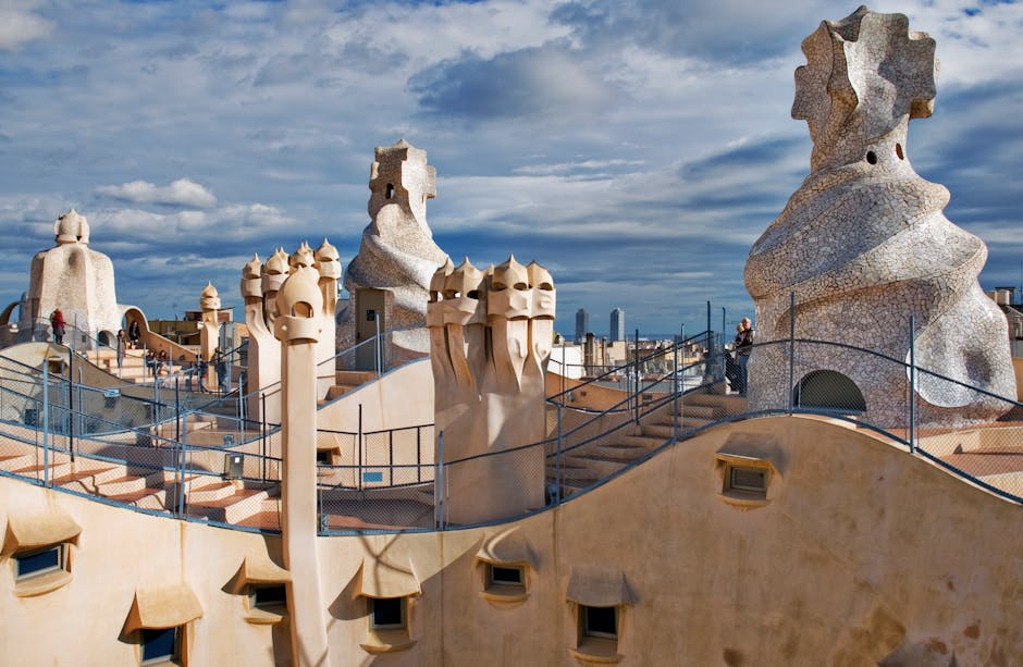 The undulating rooftop of Casa Mila with surreal warrior-helmet chimneys against the Barcelona sky