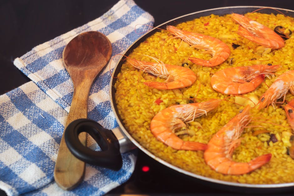 A bubbling pan of Catalan fideua with prawns and squid on top