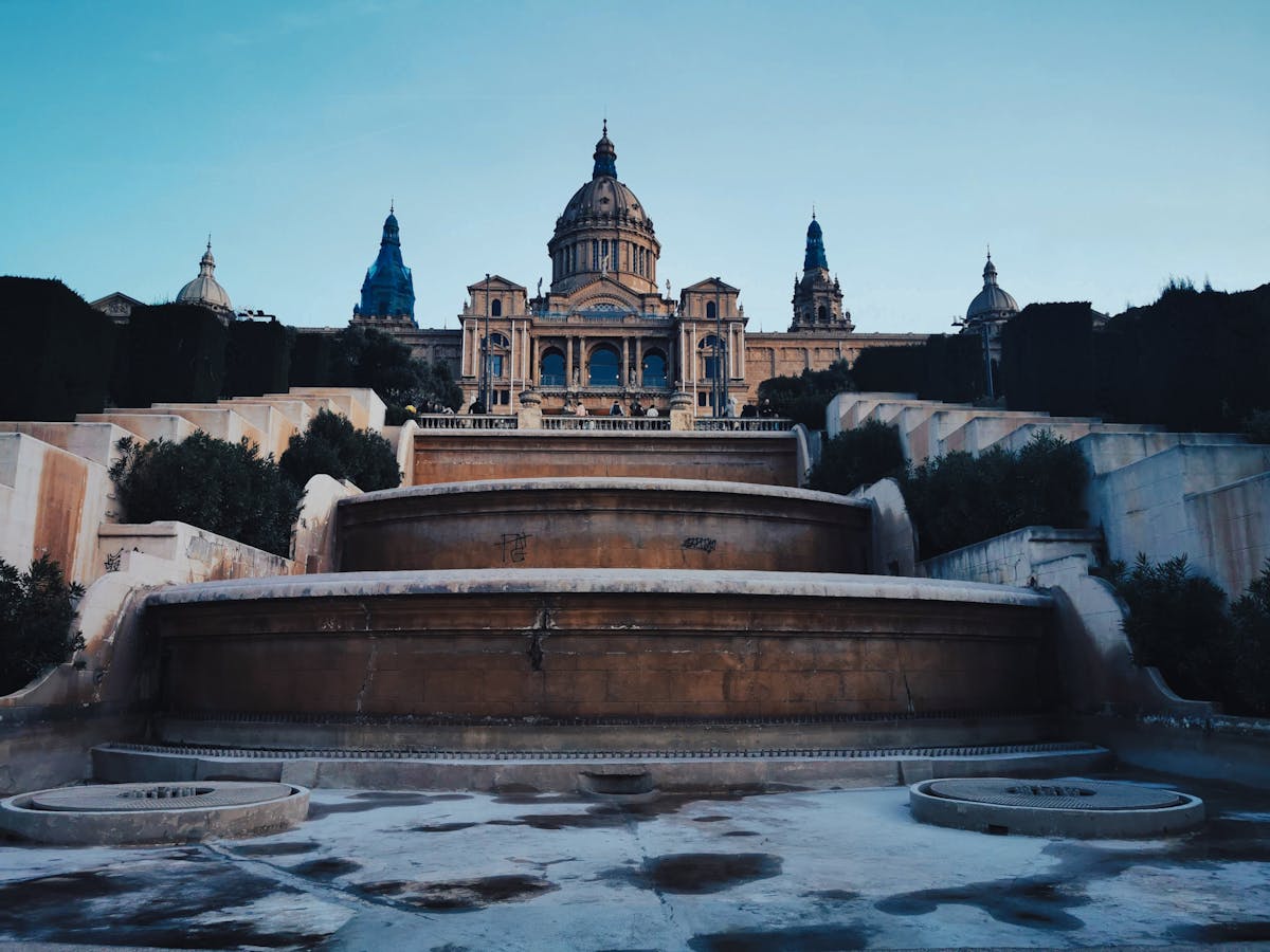 Magic Fountain of Montjuic illuminated in vibrant colors during an evening show