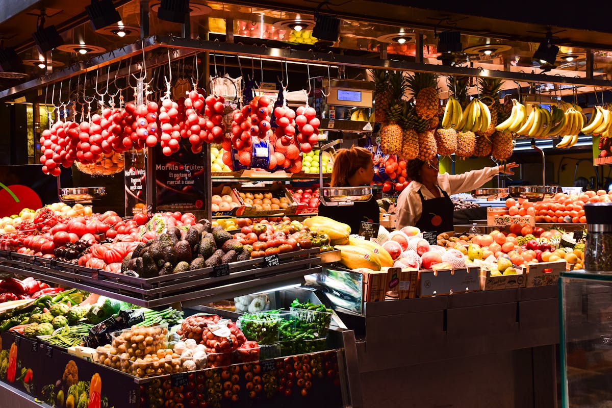 Colorful fresh fruit stalls inside La Boqueria market on La Rambla