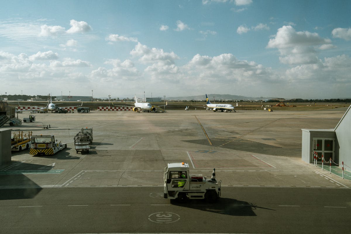 Barcelona airport terminal exterior with taxis and airport buses loading passengers for transport into the city