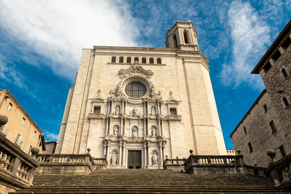 The grand staircase leading up to Girona Cathedral with medieval buildings on either side
