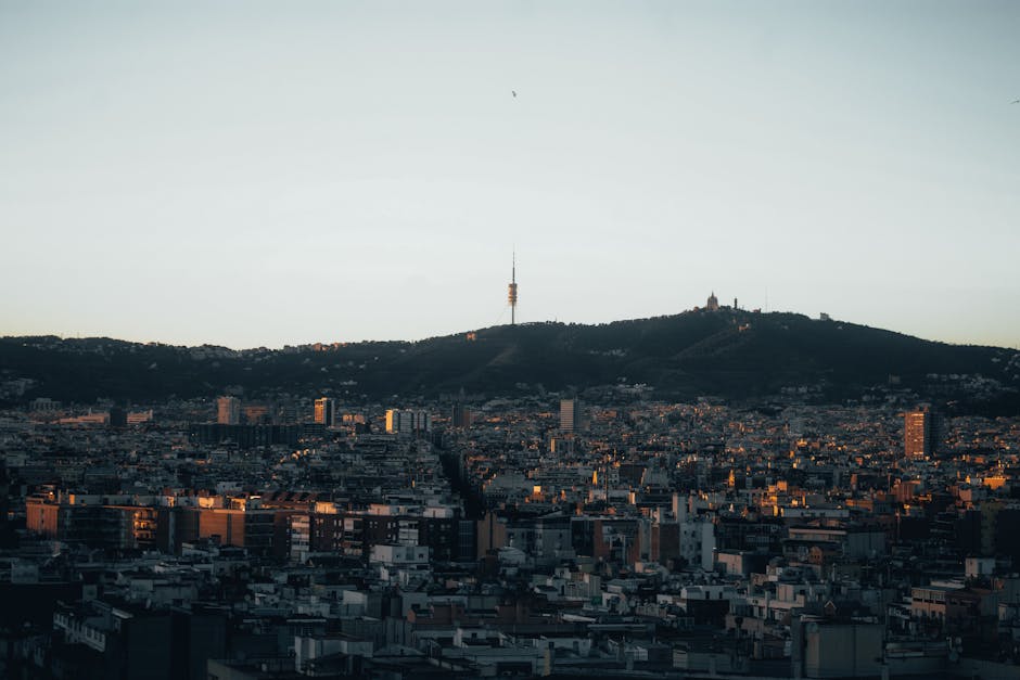 The Bunkers del Carmel viewpoint at sunset with Barcelona's skyline below