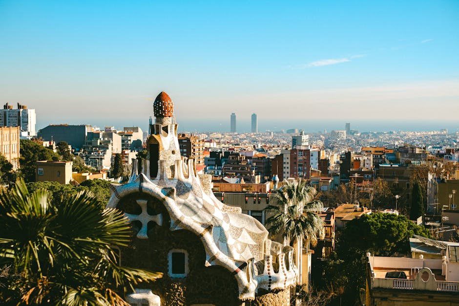 A traveller relaxing at Park Guell with Barcelona's skyline visible in the distance