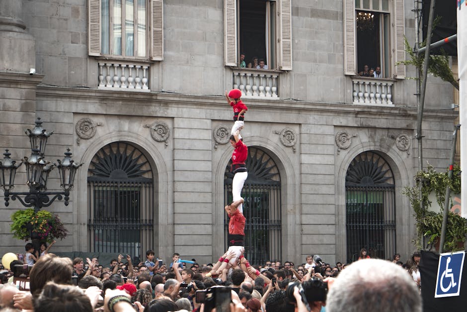 A castellers human tower rises in front of Barcelona City Hall during La Merce festival