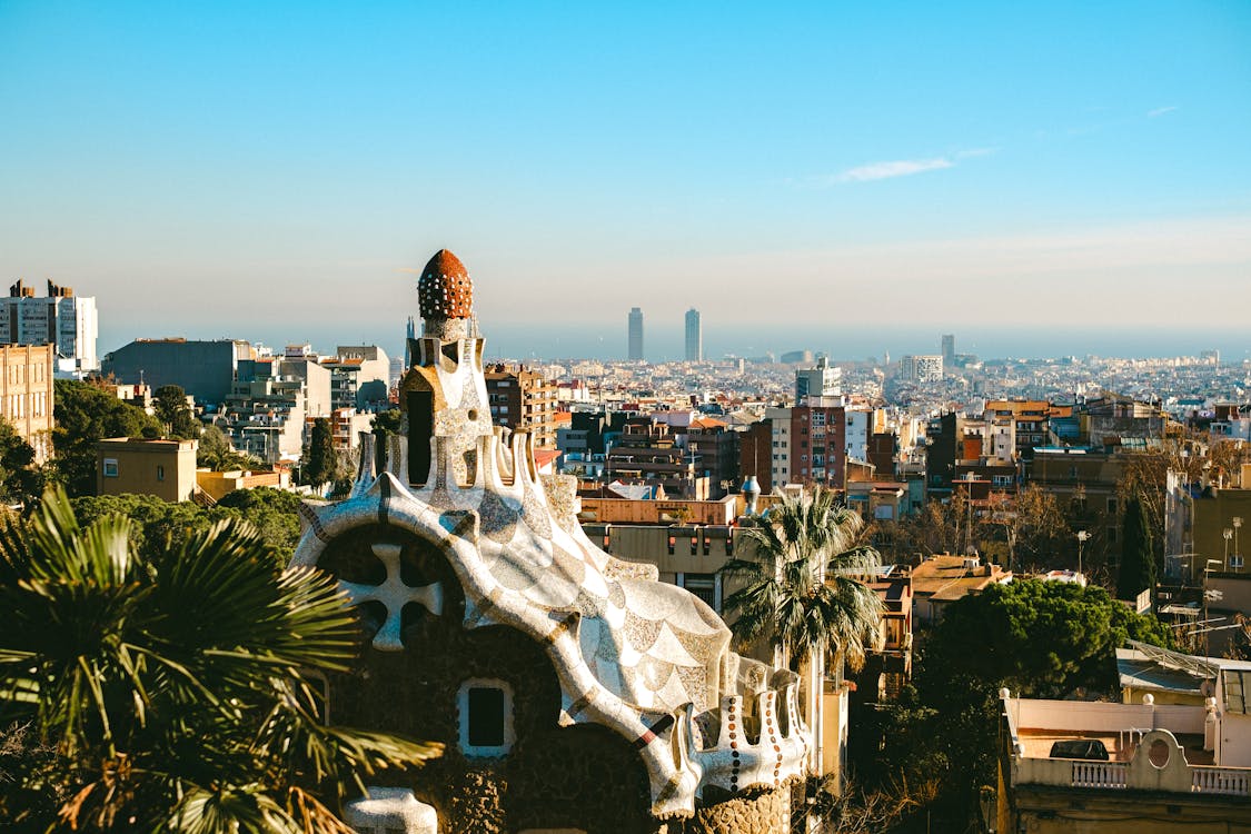 Aerial view of Park Güell mosaic architecture with Barcelona cityscape