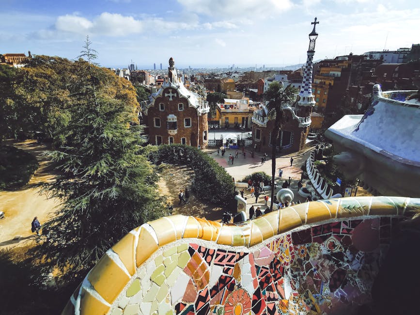 The serpentine mosaic bench at Park Guell with the Barcelona skyline in the background