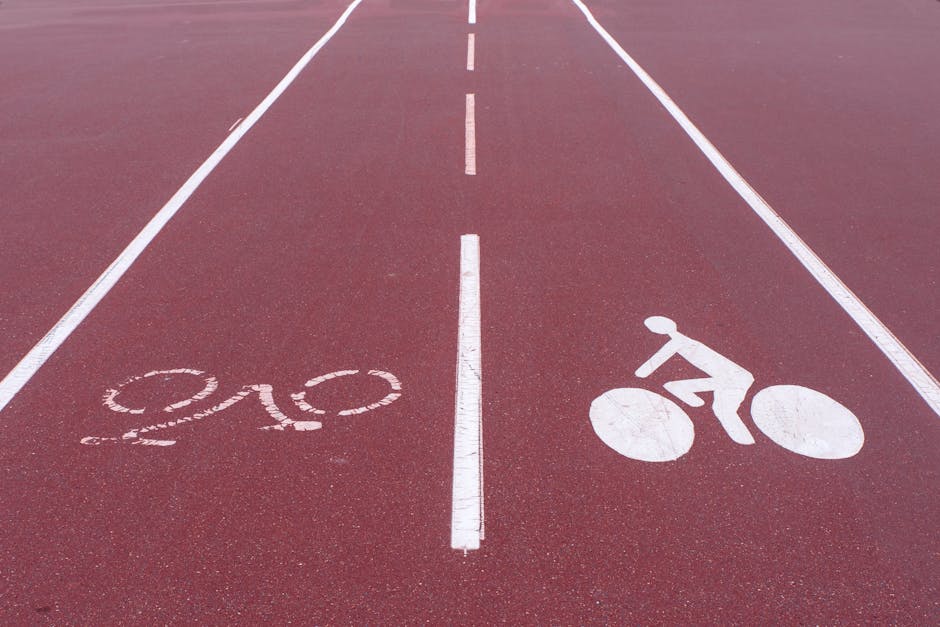A dedicated bicycle lane in Barcelona with cyclists riding past Modernista buildings