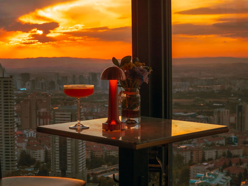 A Barcelona rooftop bar at sunset with the Sagrada Familia visible in the skyline