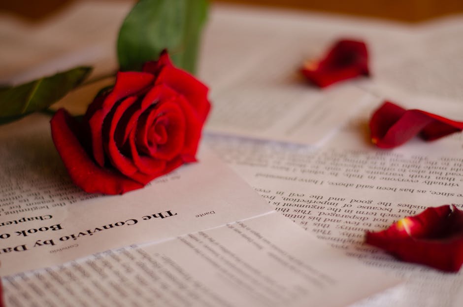 A Sant Jordi street stall in Barcelona piled high with red roses and stacks of books
