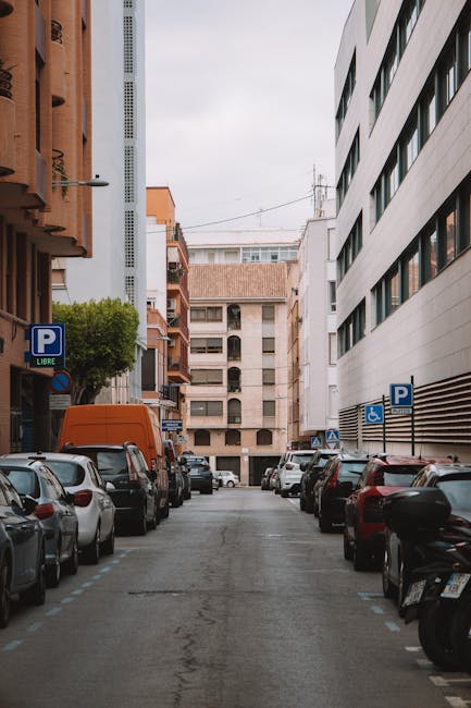 A street in Barcelona with parked cars and buildings on either side