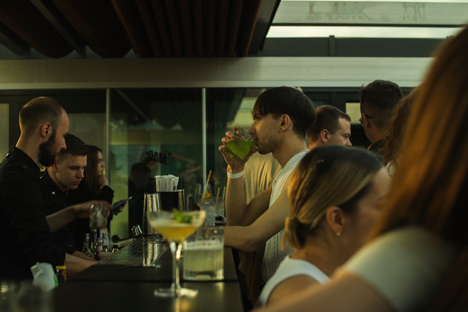 A small group enjoying drinks at a Barcelona cocktail bar during a pub crawl