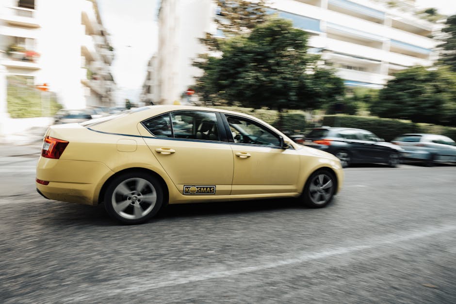 A line of yellow and black Barcelona taxis on a city street