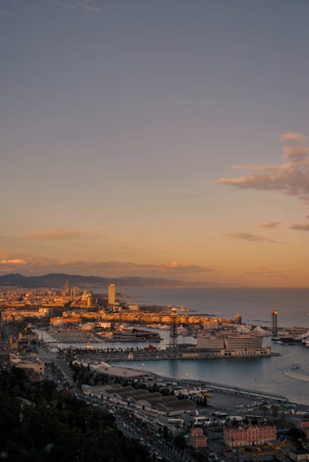 The Barcelona waterfront at sunset with the W Hotel and beach