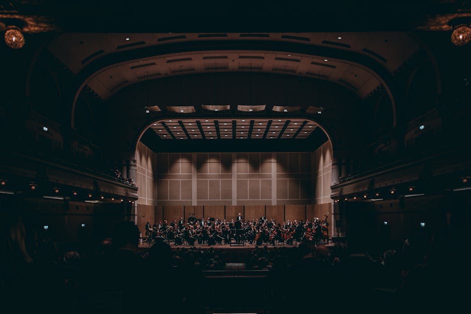 An orchestra performing on a concert hall stage