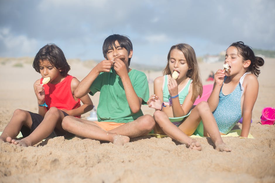 Children eating ice cream at a Barcelona beach in summer