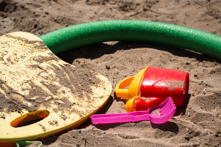 A family with children playing on a Barcelona beach with sand toys