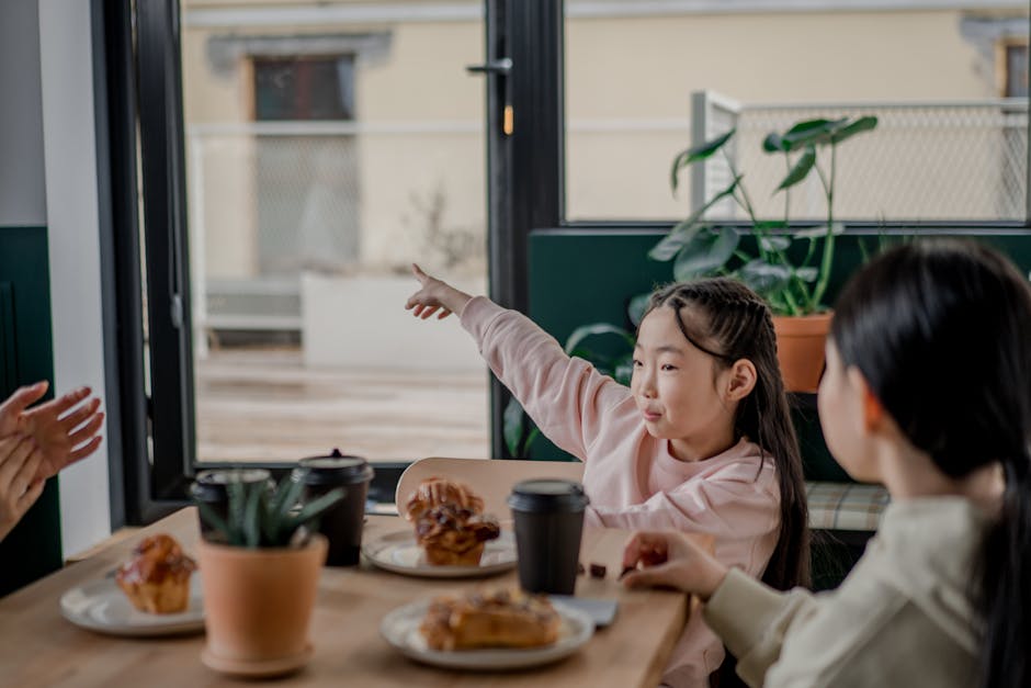 A family enjoying breakfast at a Barcelona cafe with morning sunlight