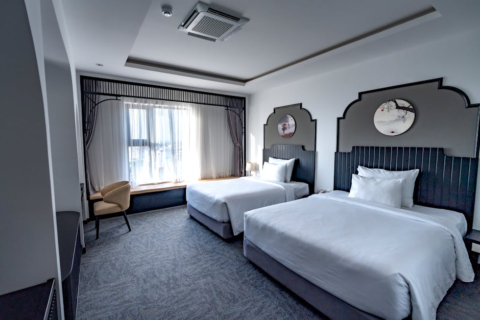 A spacious family hotel room with two double beds and bright decor