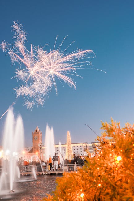 A fountain show with fireworks lighting up the night sky
