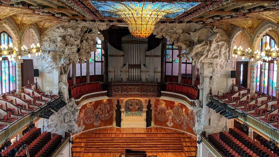 The ornate interior of a modernist concert hall with stained glass
