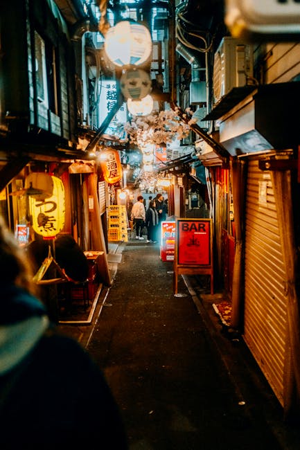 A narrow Poble Sec street lined with bars and outdoor tables in the evening