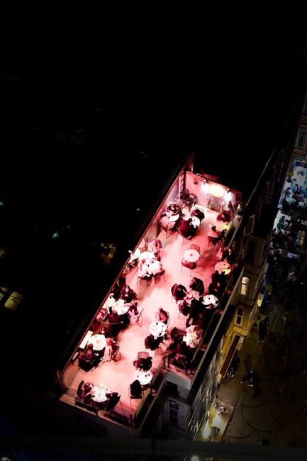 An outdoor terrace in Poble Sec with people enjoying drinks at night