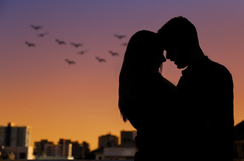 A couple watching sunset over Barcelona from a rooftop terrace