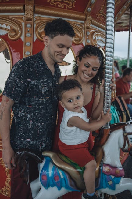 A theme park with rides, ferris wheel, and crowds during the day