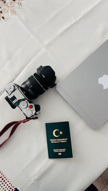 Travel documents, passport, and laptop for booking travel insurance