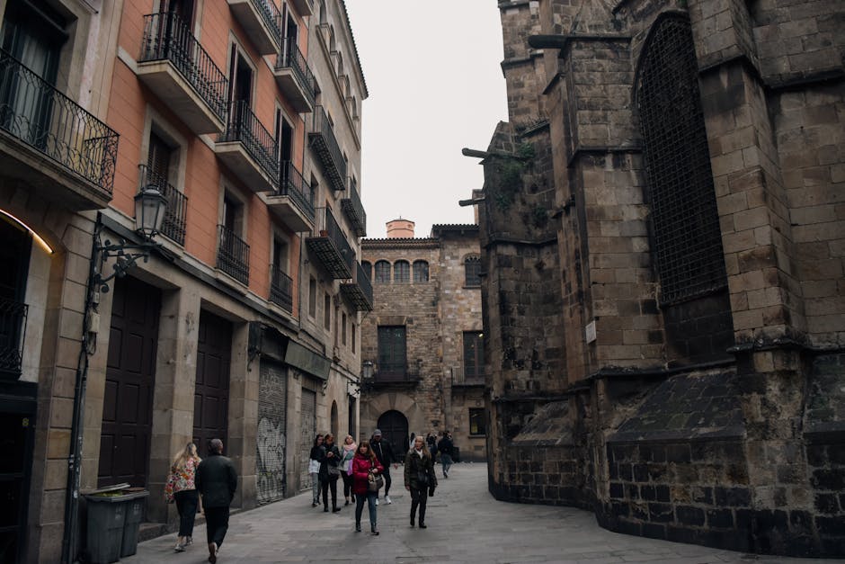 A walking tour group exploring a narrow alley in Barcelona's Gothic Quarter