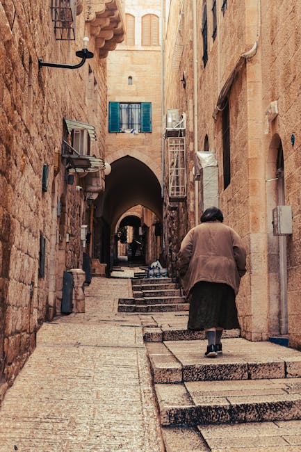 A woman walking through a narrow Old City street in Barcelona