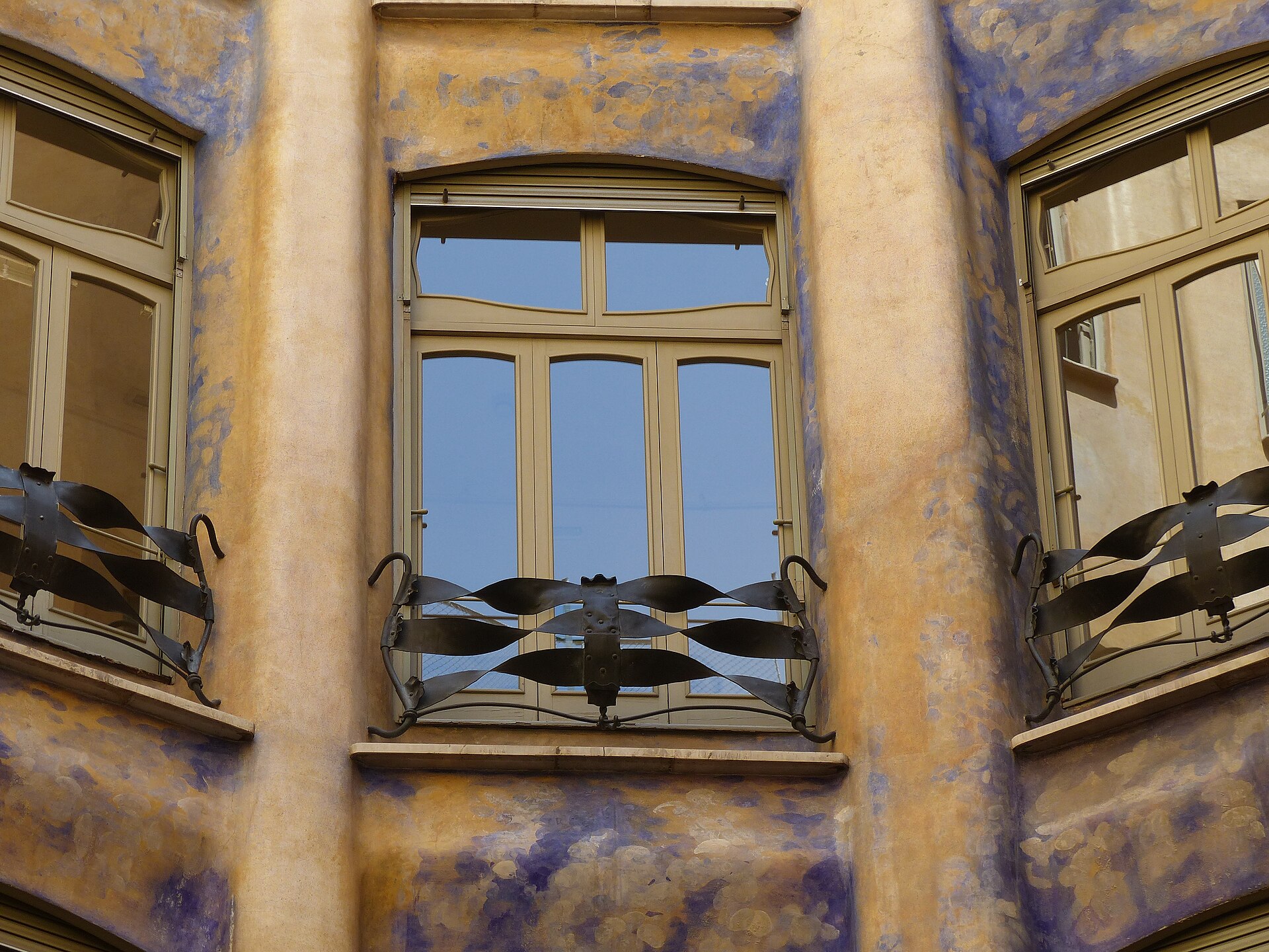Painted walls and wrought-iron balconies in the interior courtyard of Casa Mila