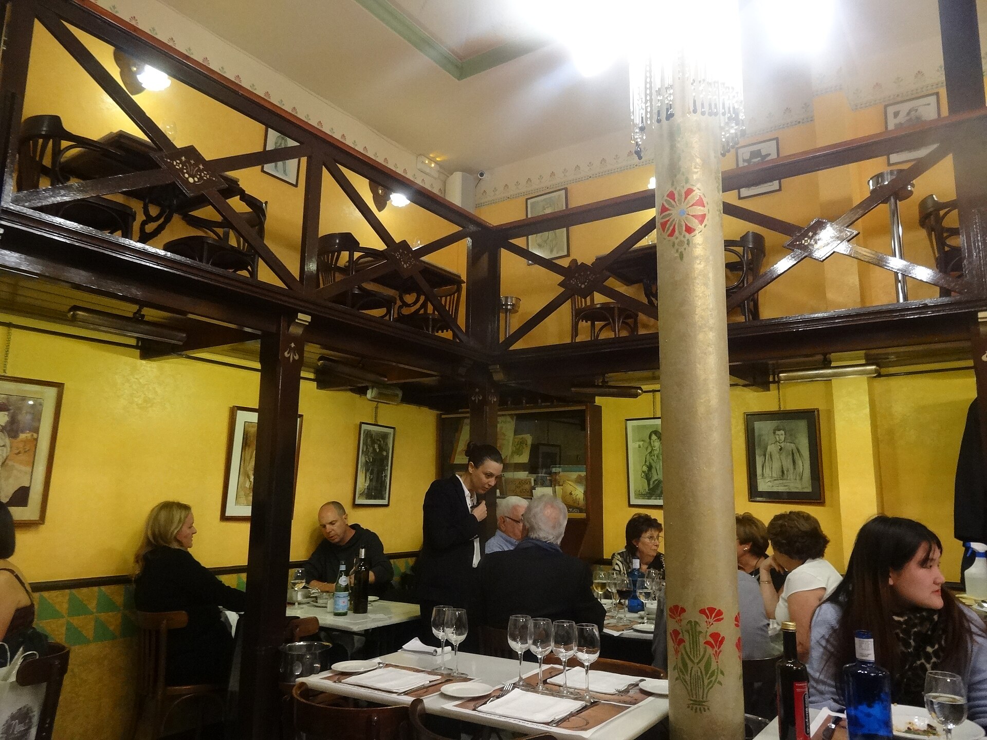 The tiled dining room of Els Quatre Gats in Barcelona with diners at white-clothed tables