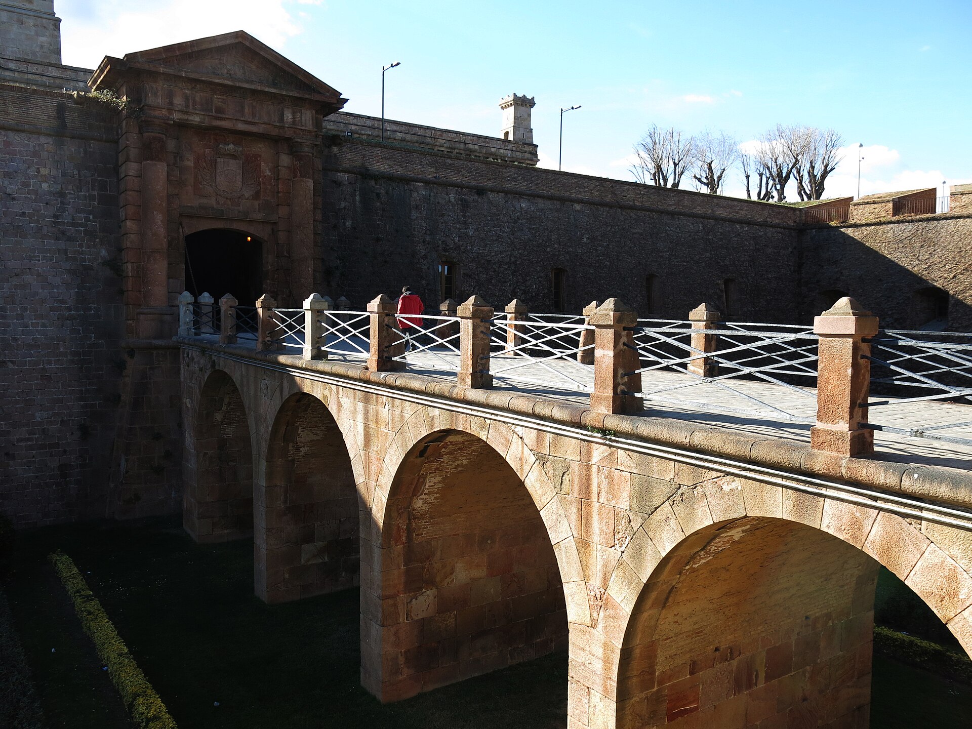 The stone bridge over the dry moat leading to the entrance gate of Montjuic Castle in Barcelona