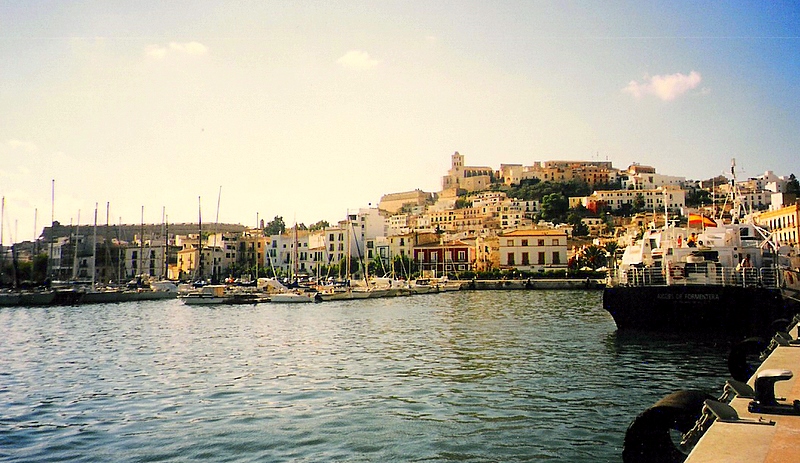 Ibiza harbour with yachts and a Formentera ferry in the foreground and the old town of Dalt Vila on the hill behind