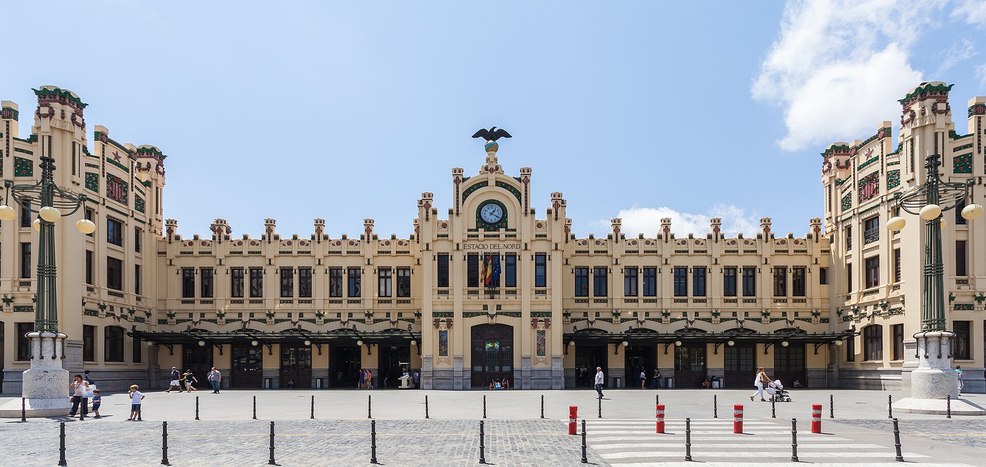 The ornate modernista facade of the Estacio del Nord in Valencia, with a clock and an eagle on the central tower